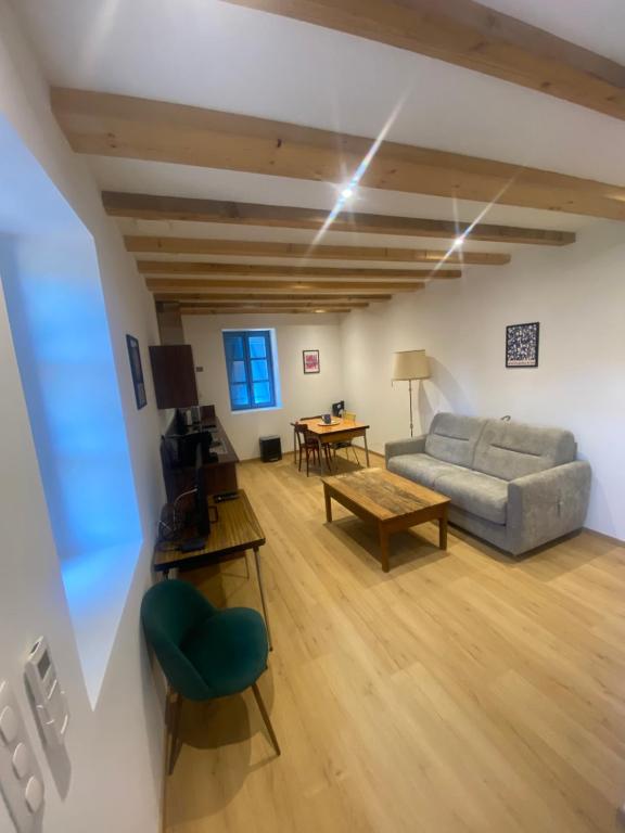 a living room with a couch and a table at Four Bas in Martel