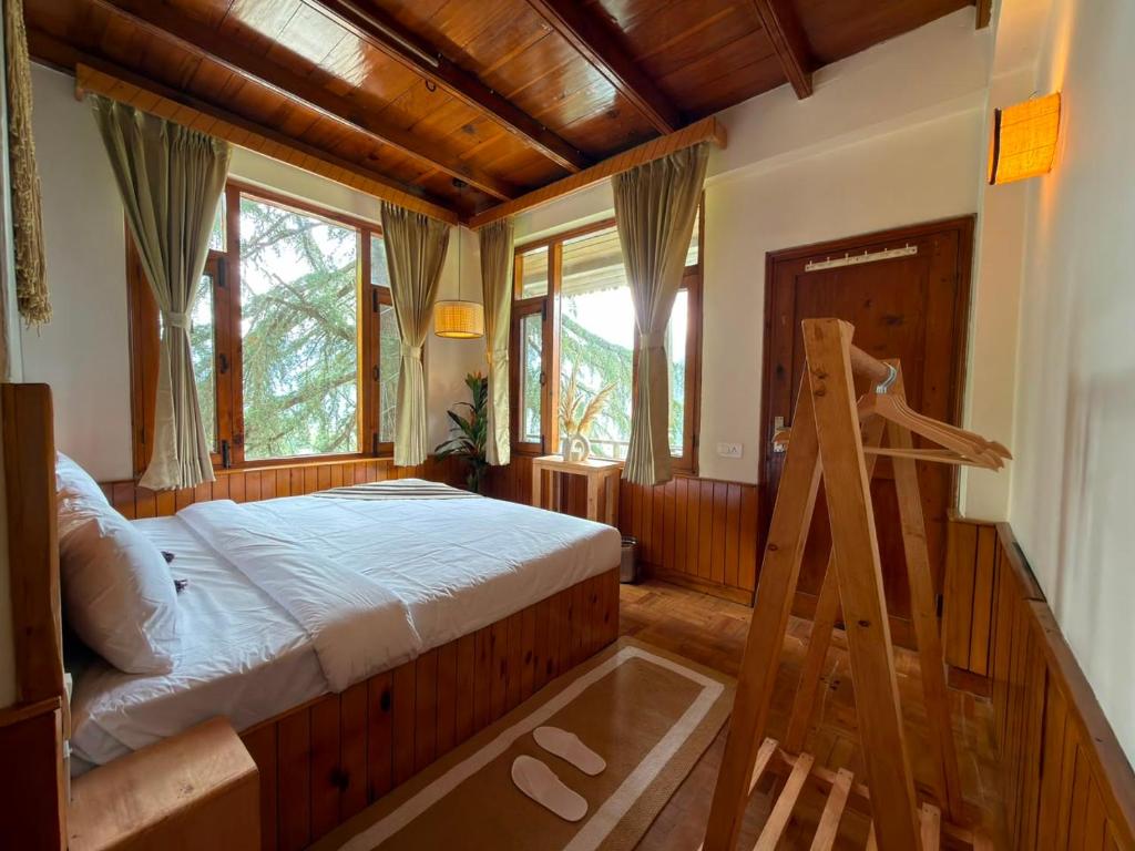 a bedroom with a bed and a ladder in it at Tora House in Nagar