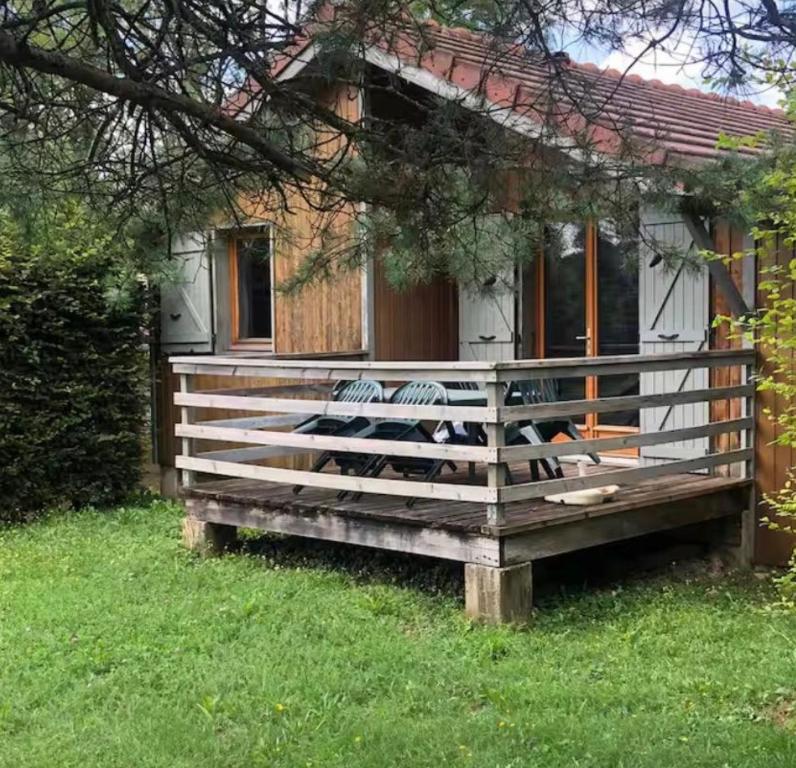 a small house with a fence in front of it at Chalet de luxe in Uxelles