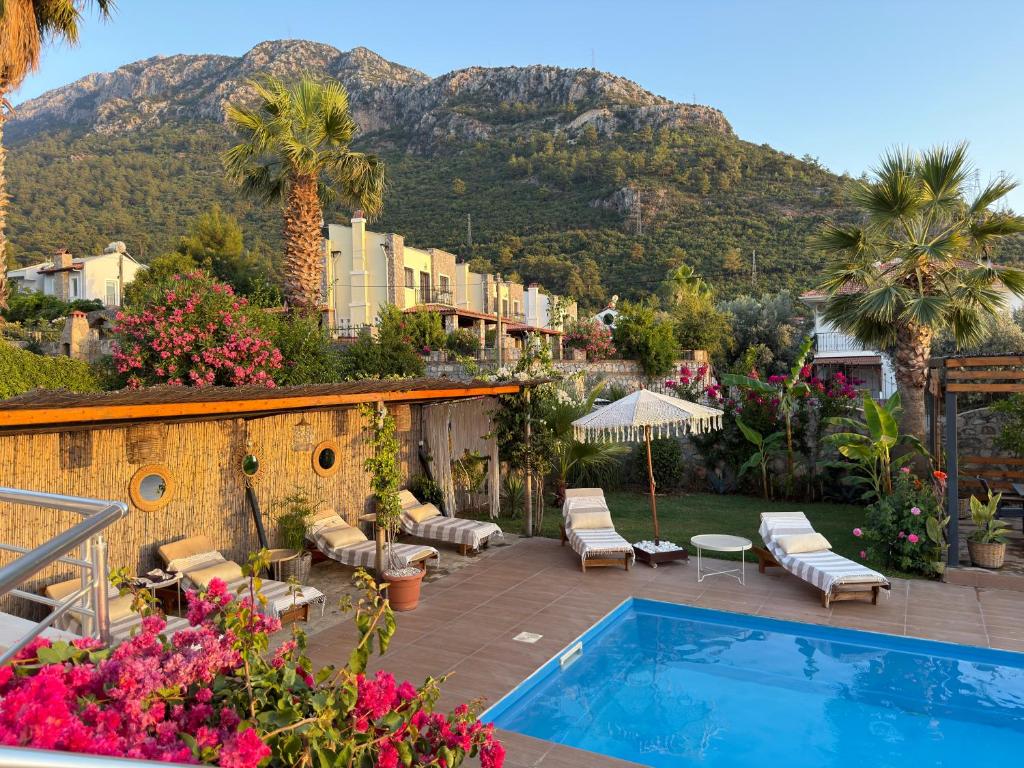a resort with a swimming pool and a mountain at Villa Zalin in Ovacik