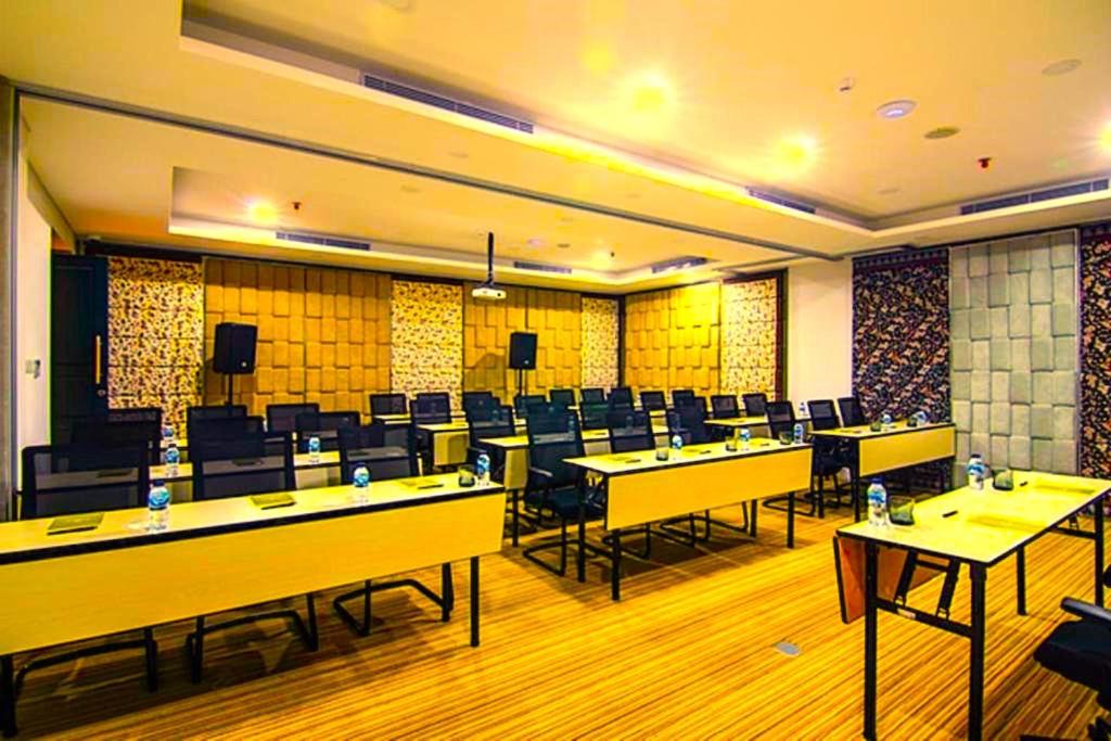 a conference room with tables and chairs in it at Hotel Radhakunj Inn in Dhanbād