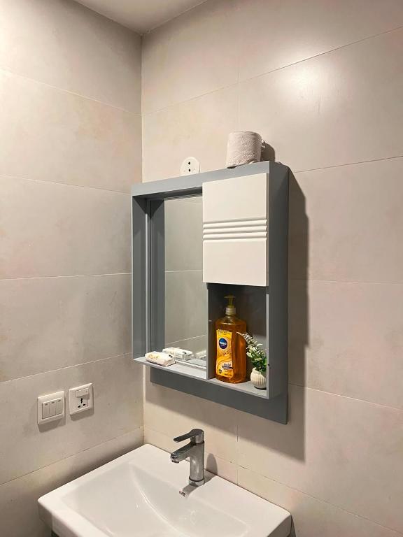 a bathroom with a sink and a mirror at Sky residences in Lahore