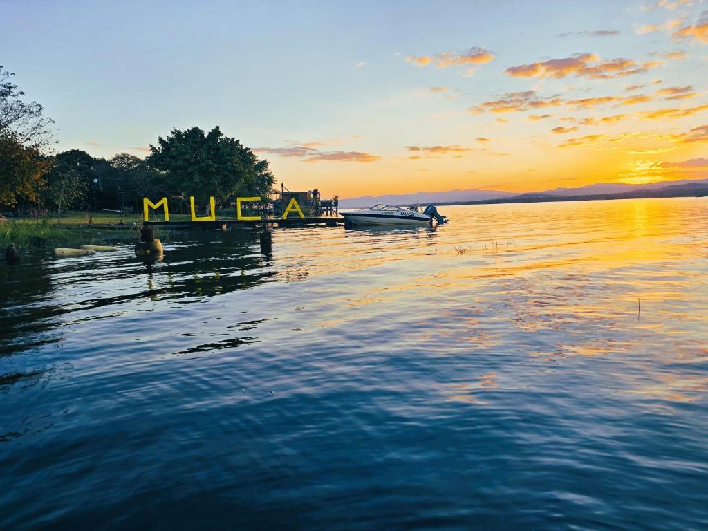 a boat on a lake with the sunset in the background at Muca House in Thohoyandou