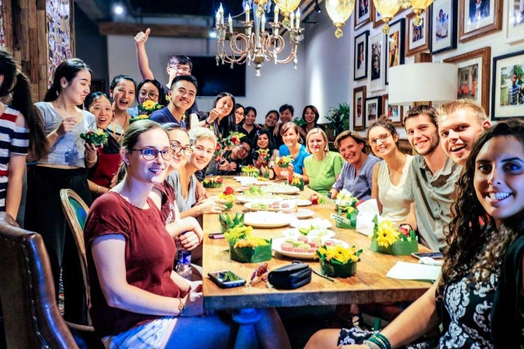 a group of people sitting around a table at SONDERIA Hostel & Bar - Lazybones in Chengdu