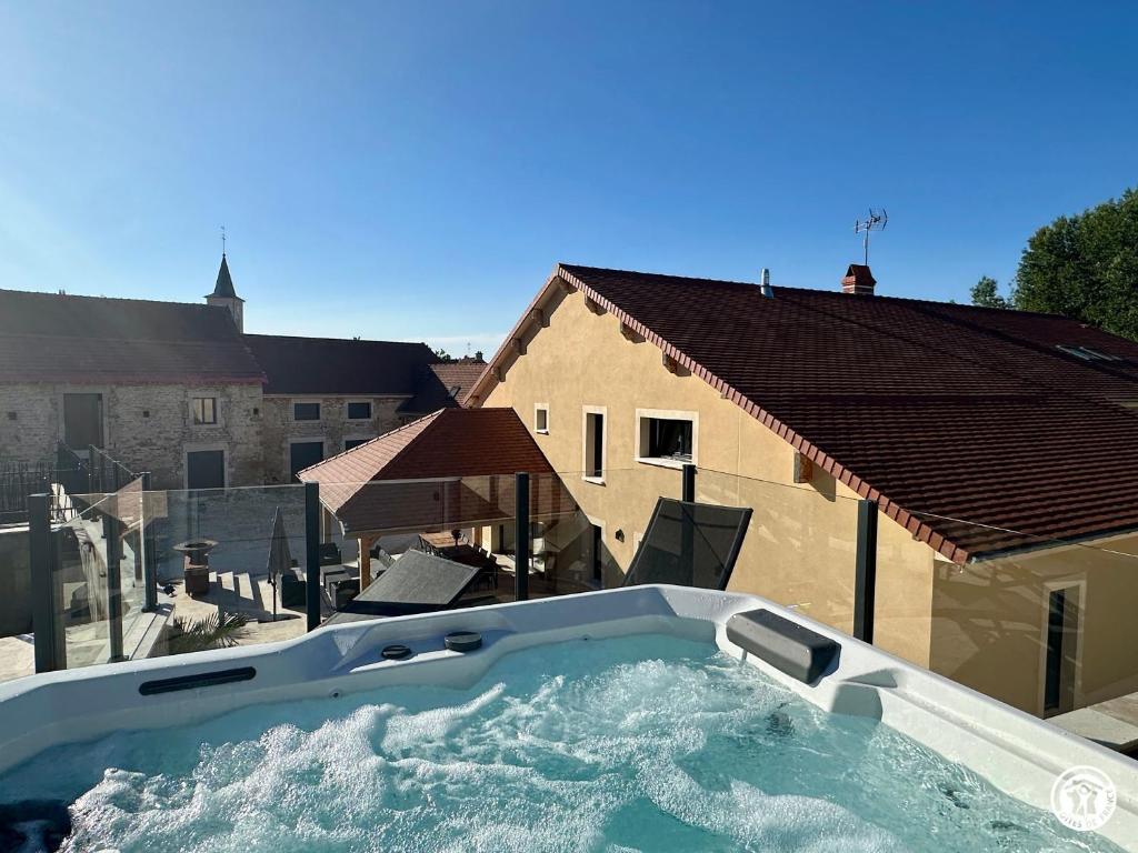 a jacuzzi tub on a balcony of a house at Gîte Côté Brevon - 8 pers in Échalot