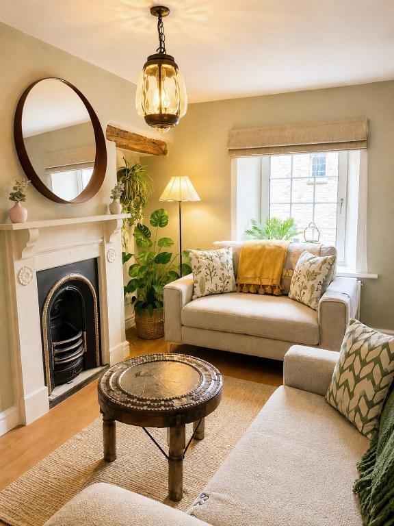 a living room with a couch and a mirror at Muddy Boots-Arcade Royale in Kirkby Stephen