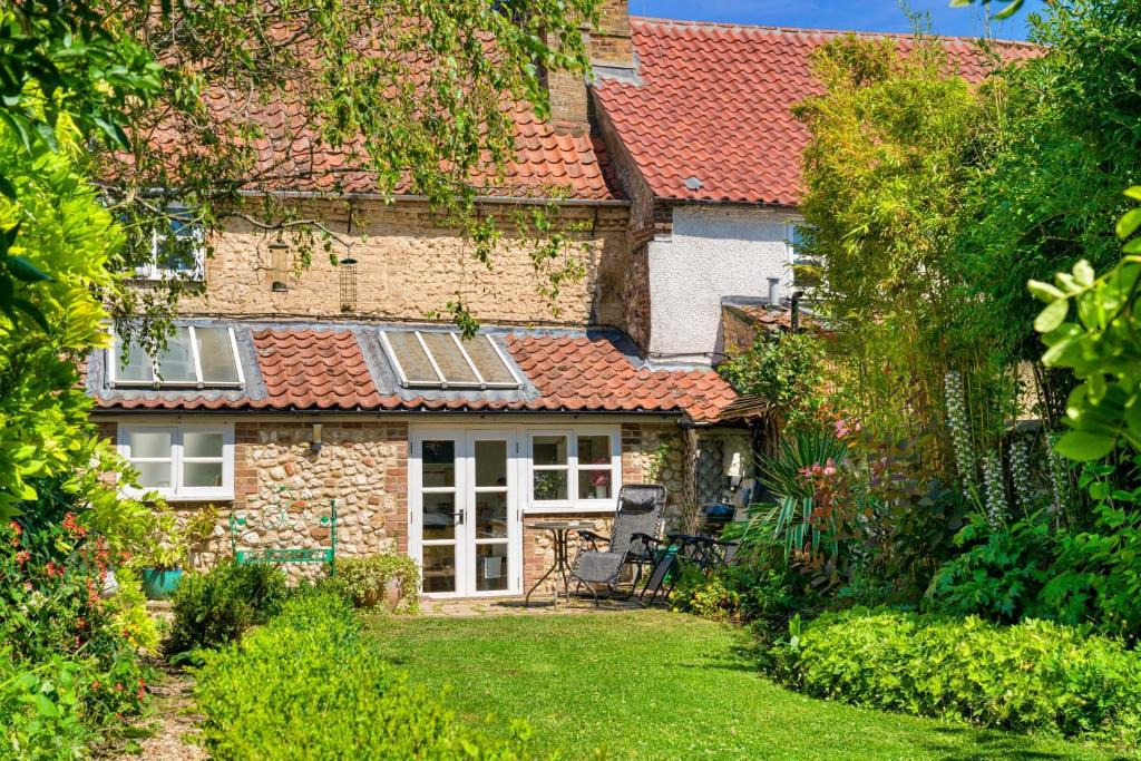 a house with solar panels on the roof at Finest Retreats - Lavender Cottage in Methwold