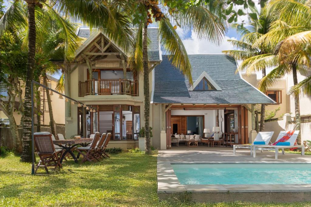 a villa with a swimming pool and a house at Villa Itzaga by muse villas in Post of Flacq