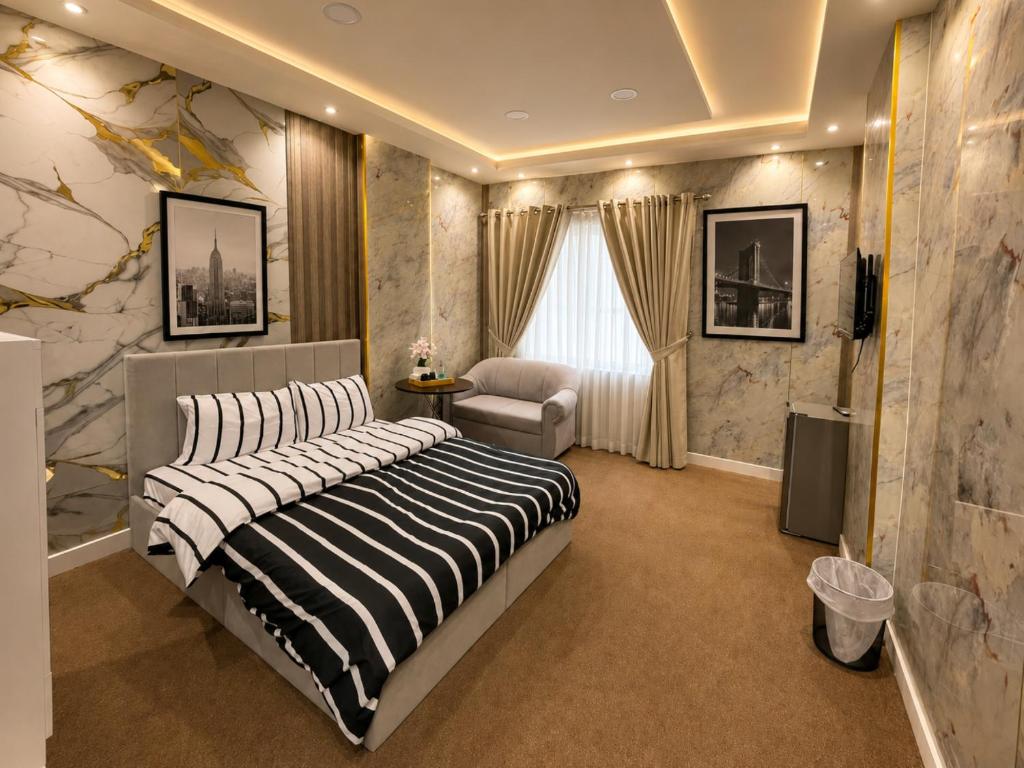 a bedroom with a bed and a chair in it at Royal International in Abu Dhabi