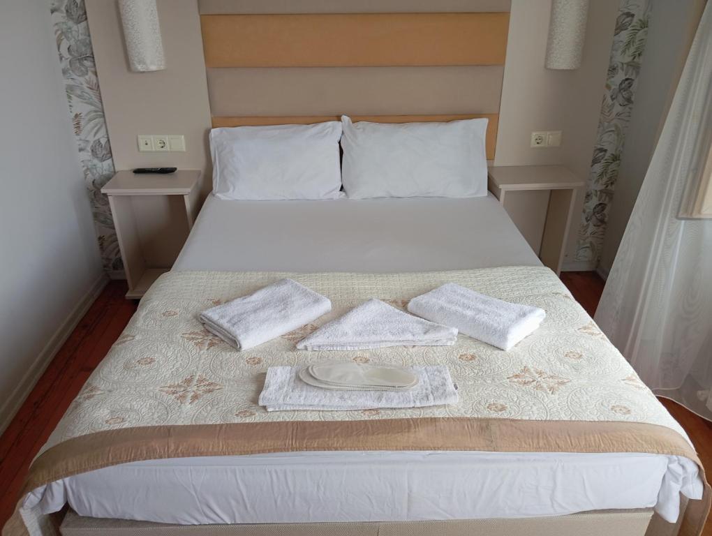 a bed with two towels and a plate on it at Sunset Otel in Şile