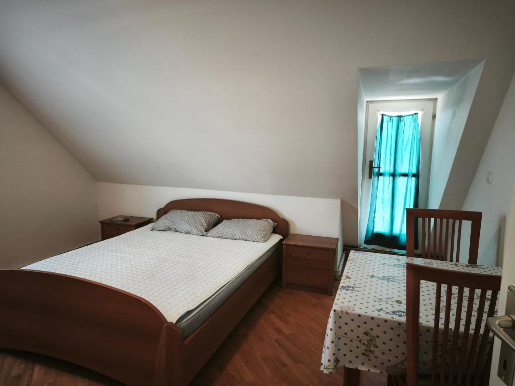 a bedroom with a bed and a table and chairs at Beli oblaki in Gradišče v Slovenskih Goricah