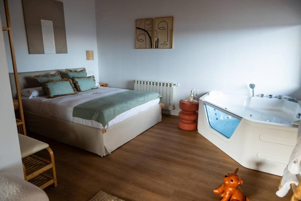 a bedroom with a bed and a bath tub at Casas del Tremedal in Tremedal