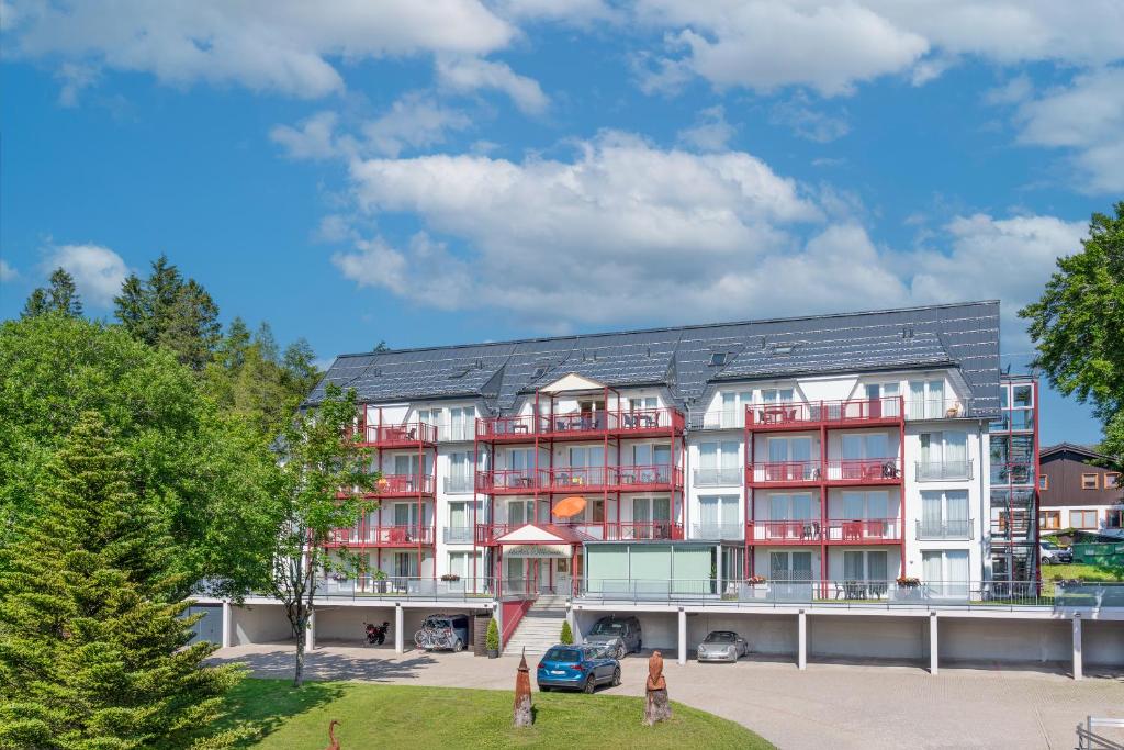 an apartment building with red and white at Chalet Sonnenhang Oberhof in Oberhof
