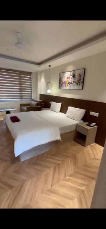 a large bedroom with a large white bed in it at GRiK STAY in Greater Noida