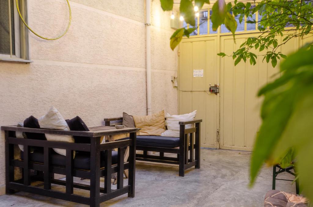 two chairs and a table with pillows on them at Buff Hostel Tirana in Tirana