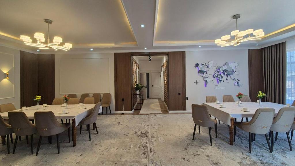 a conference room with tables and chairs and a map on the wall at Beypil Place in Kochkorka