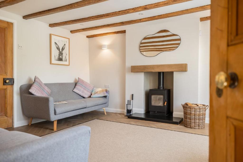 a living room with a couch and a fireplace at Eighteen Pottergate in Helmsley