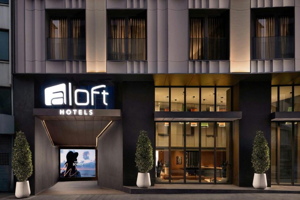 a hotel with a sign on the front of a building at Aloft by Marriott Istanbul Karakoy in Istanbul
