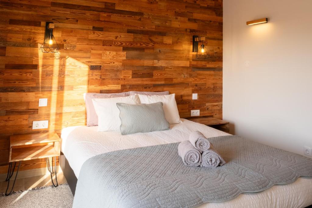 a bedroom with a bed with towels on it at Vida Pura Guesthouse in Odeceixe