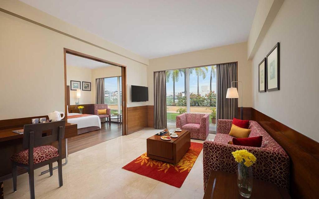 a hotel room with a bed and a living room at Fortune Select Exotica, Navi Mumbai - Member ITC Hotels' Group in Navi Mumbai