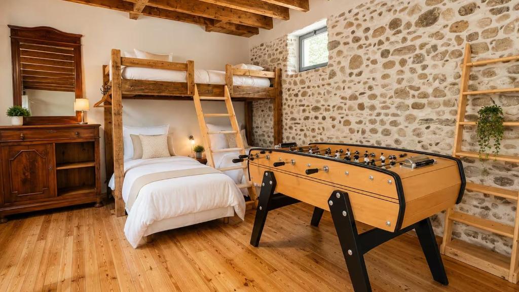 a bedroom with a pool table and a bunk bed at Gîte de l 'Annonciation in Lourdes