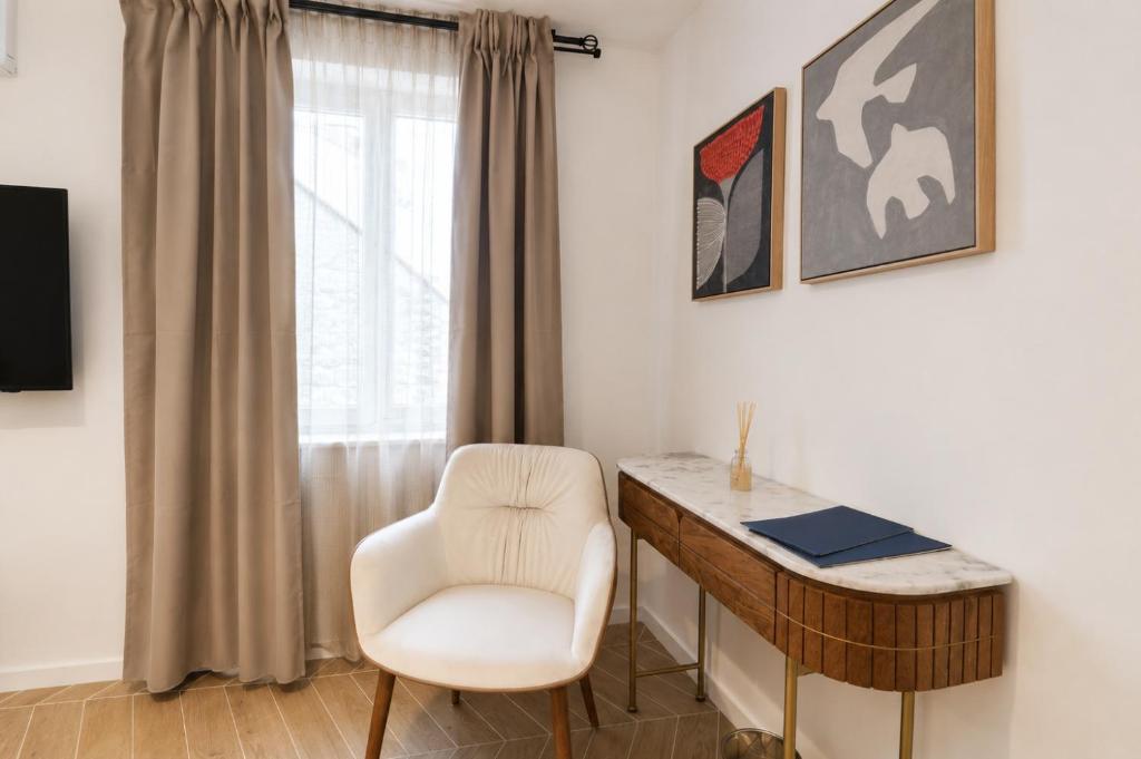 a white chair and a desk in a room at Villa Mater in Trogir