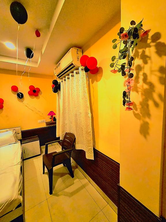 a room with a bed and a window with balloons at Galaxy Stellar Suites in kolkata