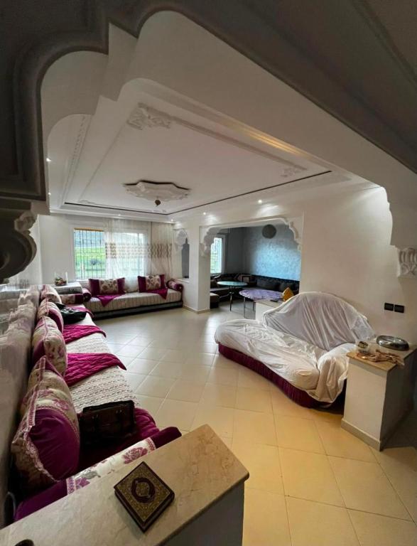 a large room with two beds and a couch at naderi in Tangier
