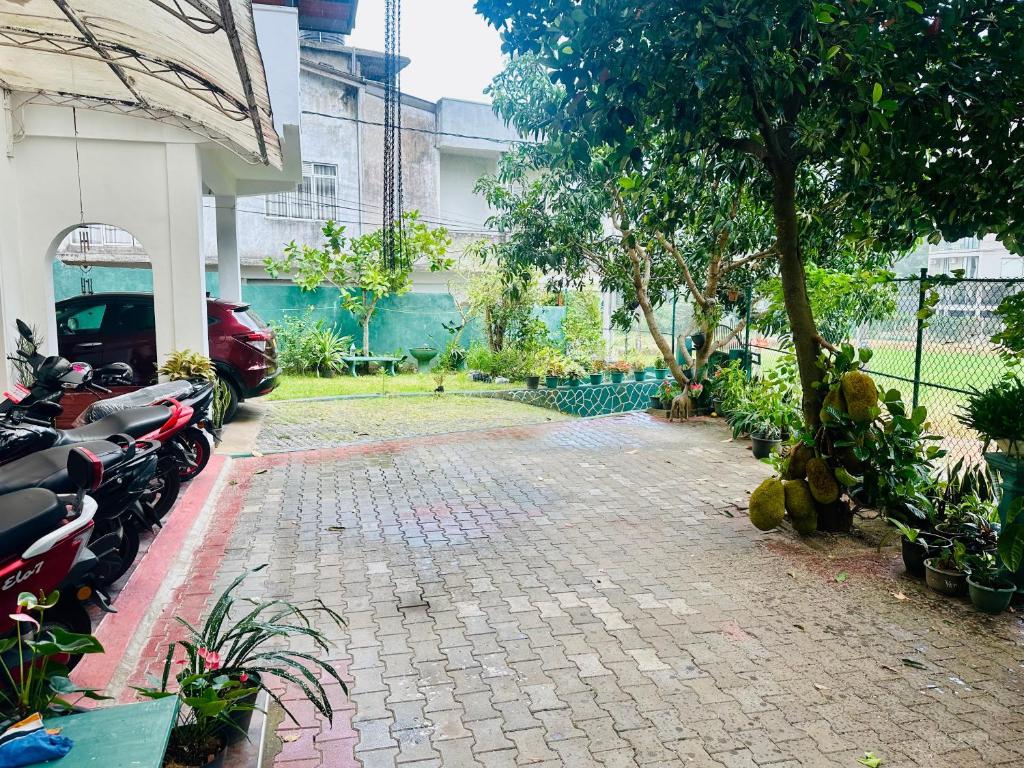 a courtyard with motorcycles parked next to a building at The Shire in Kandy