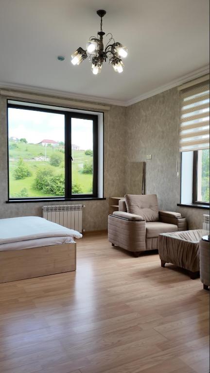 a bedroom with a bed and a couch at Sadaxlı Hotel & Restaurant in Şǝrǝdil