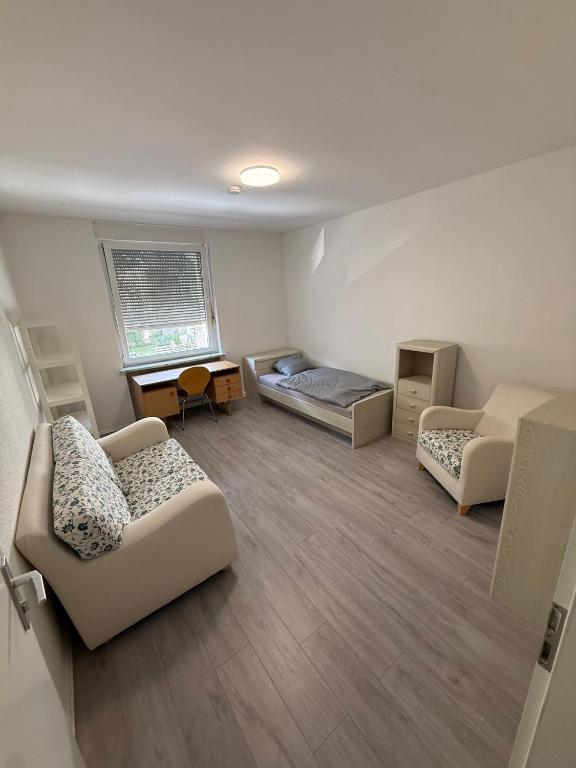 a living room with two beds and a couch at Monteurzimmer Schölerpad 24h Self Check in in Essen