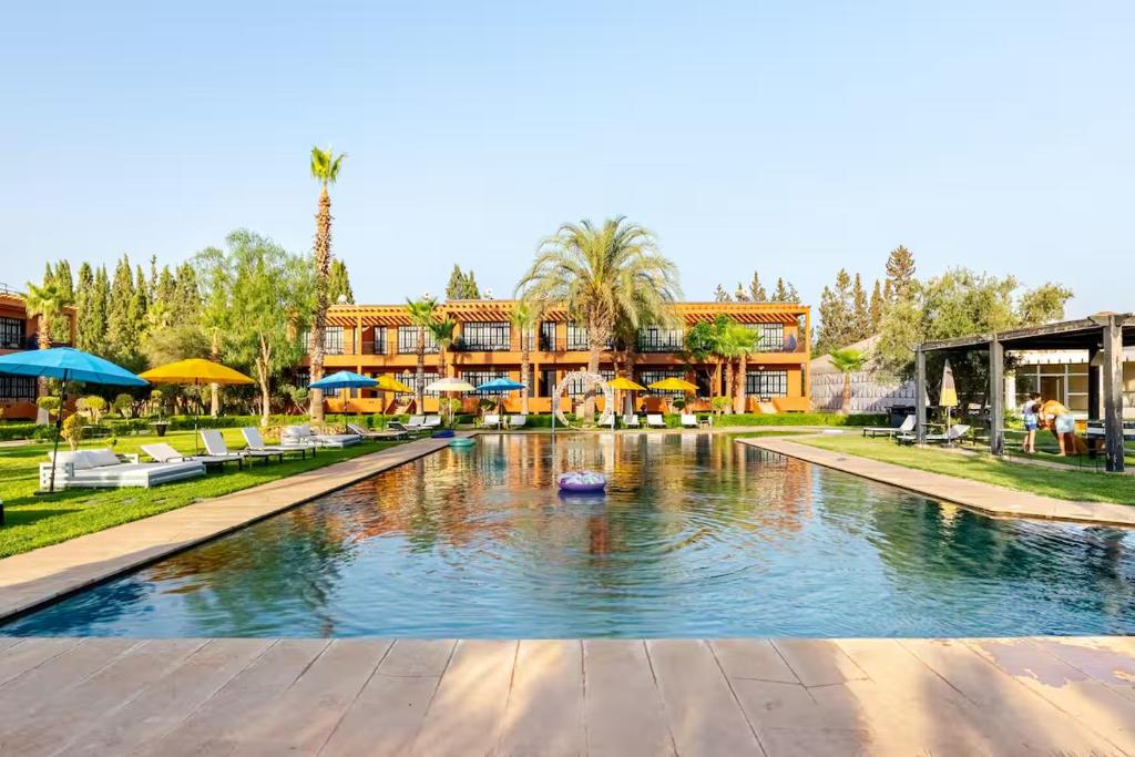 a resort with a pool in front of a building at MVIEW Villas in Marrakesh