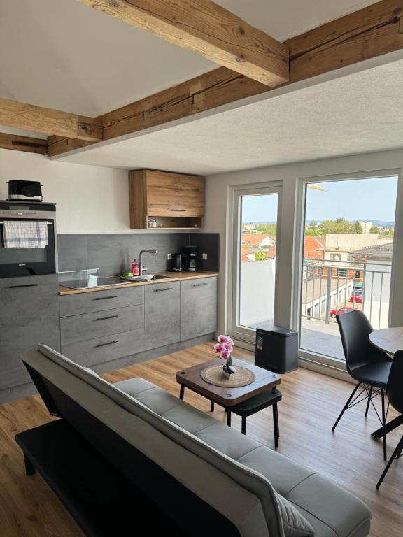 a living room with a couch and a table at Bodenseeapartments in Friedrichshafen