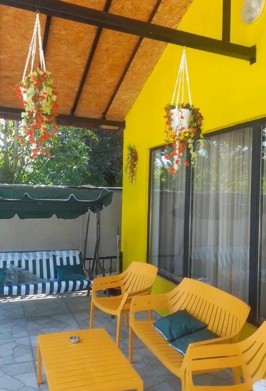 a patio with two chairs and a table and a couch at Paradise Mtskheta in Tbilisi City