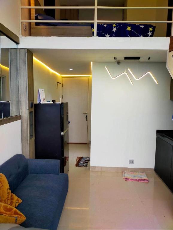 a living room with a couch and a loft bed at Deed Apartemen in Gresik