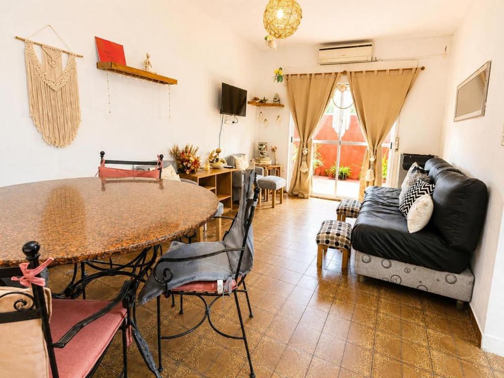a living room with a table and a couch at Olivos Stay in Olivos