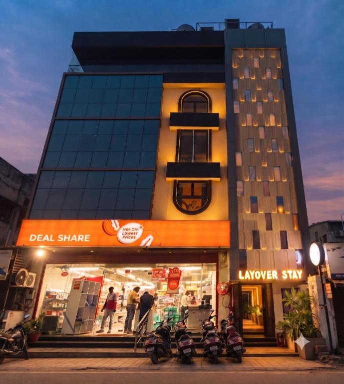 a store front of a building with motorcycles parked outside at Hotel Layover Stay-3 Minutes From the Airport in Jaipur
