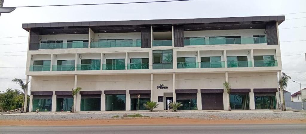 a large white building with green balconies on it at Résidence Leyla in Abidjan