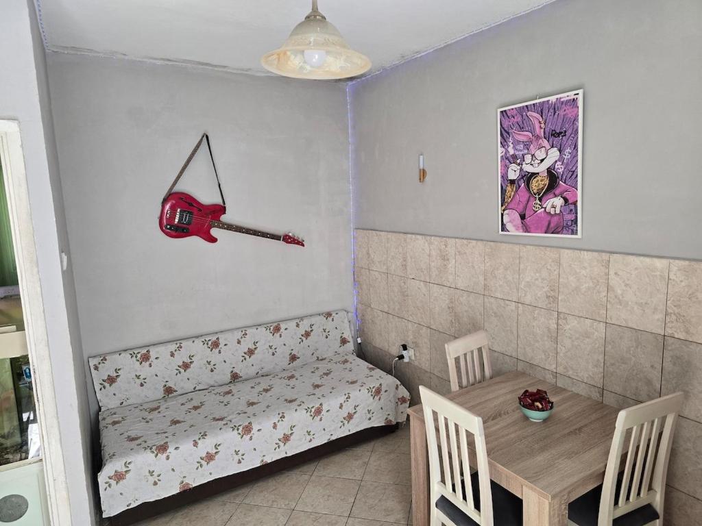 a small room with a table and a baseball bat on the wall at Lina in Dobrota