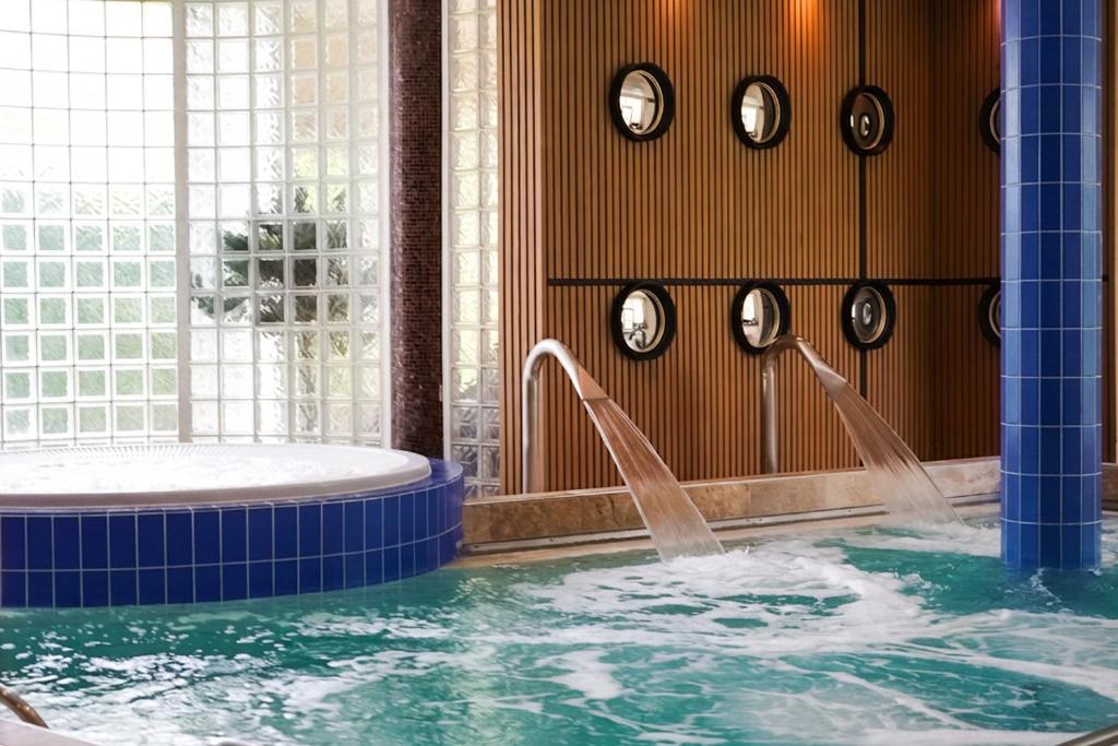 a hot tub with water coming out of it at Quintessia in Orvault