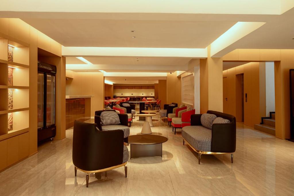 a living room with couches and chairs in a room at Ivy Hotel Lagos Ikeja in Hausa