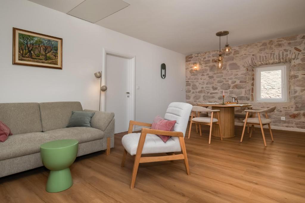 a living room with a couch and a table at Sizgoric Palace Suites Sibenik in Šibenik