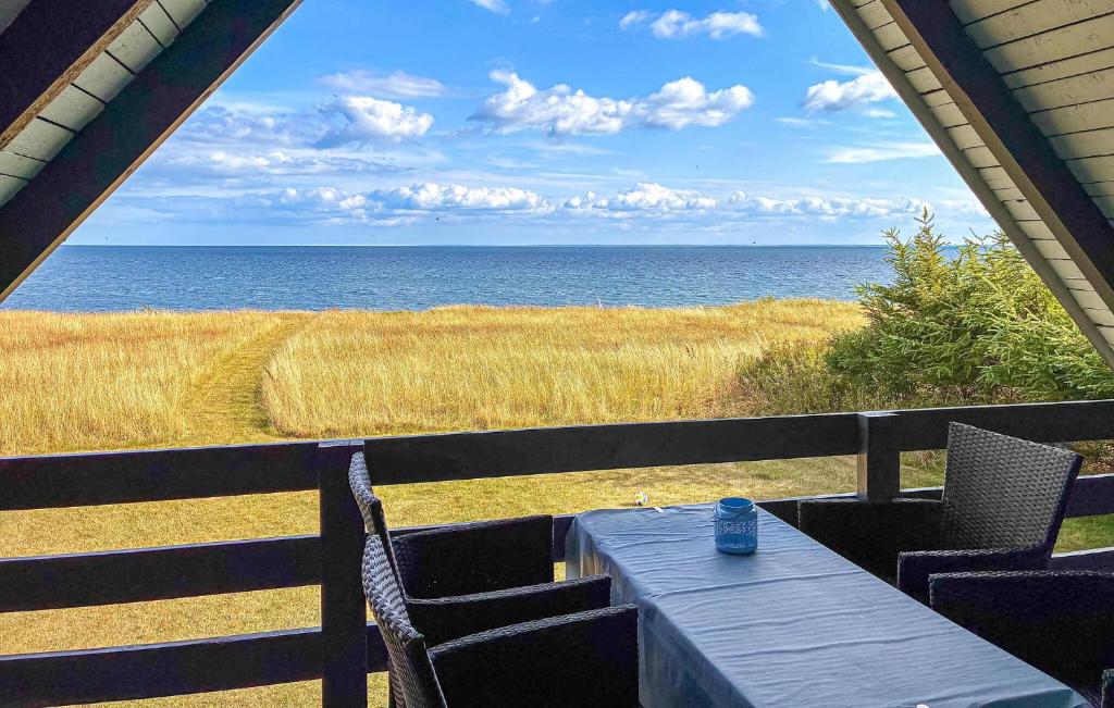 a table with chairs and a view of the ocean at Awesome Home In Haderslev With Wifi in Haderslev