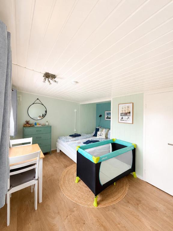 a bedroom with a bed and a desk in it at Finnenhaus 8 in Lübeck