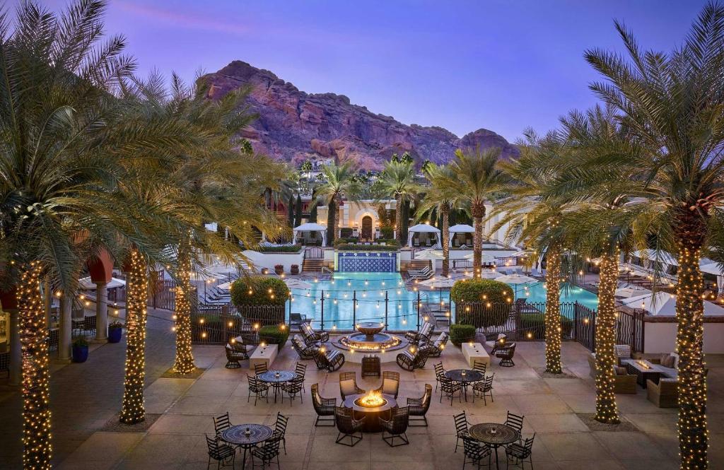 a resort with palm trees and a swimming pool at Omni Scottsdale Resort & Spa at Montelucia in Scottsdale