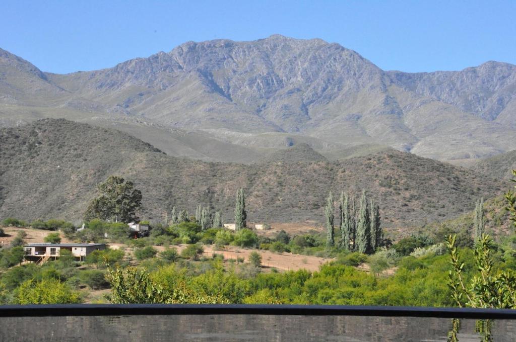 a view of a mountain range with mountains in the background at Schuilhoek Cottage - Your perfect hide away! in Calitzdorp
