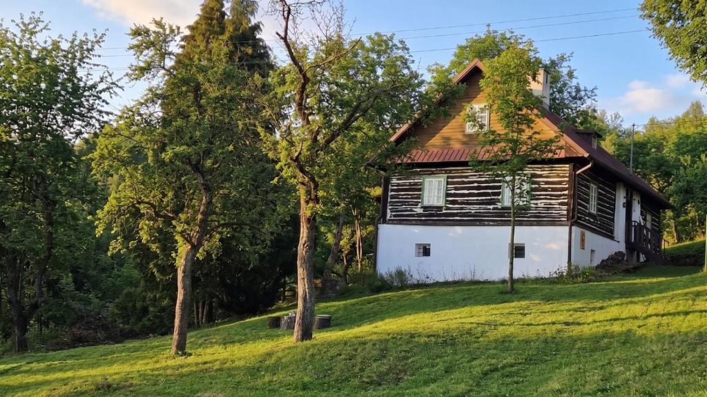 an old house on a hill with trees at Roubenka Vendryně in Vendryně