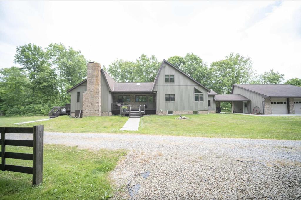 a large white house with a gravel driveway at Agape Aldea in Jamestown
