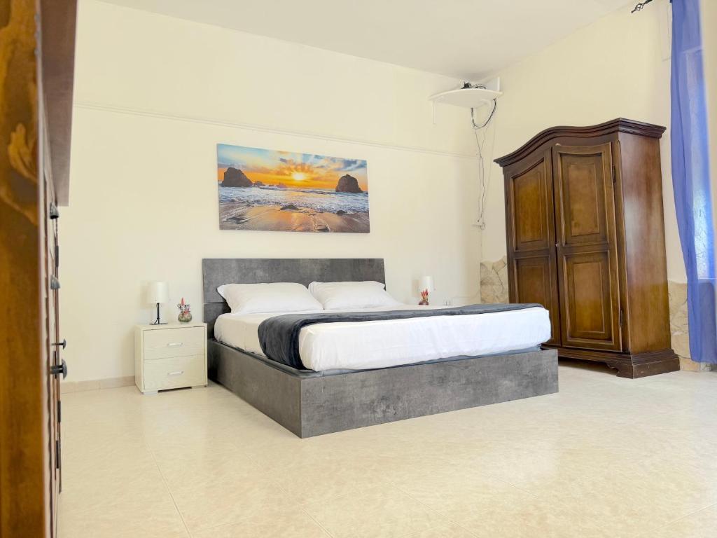 a bedroom with a bed and a painting on the wall at Only Teens - Baia Verde in Baia Verde