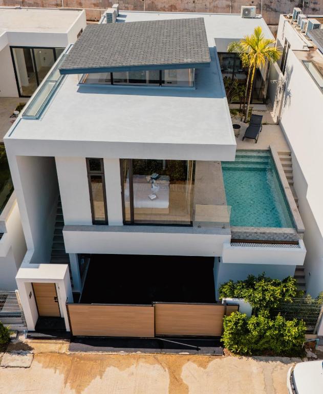 an aerial view of a house with a swimming pool at Villa Kauri 3BR Pool Villa at Aileen Naithon in Ban Sakhu